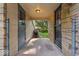 Covered porch with stone columns and walls leading to backyard at 4807 Graceland Ave, Indianapolis, IN 46208
