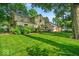 A lush green backyard with mature trees offering plenty of shade at 4807 Graceland Ave, Indianapolis, IN 46208