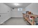Spacious basement with concrete floor, ample lighting, and work bench at 4807 Graceland Ave, Indianapolis, IN 46208