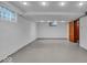 A large basement with concrete floors, recessed lighting and glass block windows at 4807 Graceland Ave, Indianapolis, IN 46208