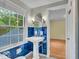 Bathroom with blue tile, pedestal sink, and window at 4807 Graceland Ave, Indianapolis, IN 46208