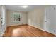 Bedroom featuring refinished hardwood floors, one window, and door at 4807 Graceland Ave, Indianapolis, IN 46208