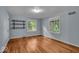 Bedroom featuring hardwood floors, natural light, and built in shelves at 4807 Graceland Ave, Indianapolis, IN 46208