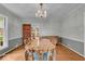Elegant dining room with hardwood floors, a chandelier, and a doorway leading to an adjacent room at 4807 Graceland Ave, Indianapolis, IN 46208