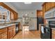 Classic kitchen with wood cabinets, black appliances, and unique patterned flooring at 4807 Graceland Ave, Indianapolis, IN 46208