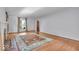 Warm and inviting living room with a fireplace, wood floors, oriental rug, and a door to another room at 4807 Graceland Ave, Indianapolis, IN 46208