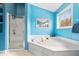 Bright blue bathroom boasts a soaking tub and a separate shower at 8418 Mesic Ct, Indianapolis, IN 46278