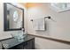 Powder room featuring glass vessel sink, black cabinet and trim, and decorative mirror at 8418 Mesic Ct, Indianapolis, IN 46278