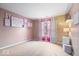 Spacious bedroom with pink walls and colorful decor; ample natural light at 8418 Mesic Ct, Indianapolis, IN 46278