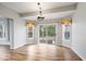 Bright dining area features hardwood floors, modern lighting, and sliding door access to the deck at 8418 Mesic Ct, Indianapolis, IN 46278