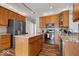 Well-equipped kitchen with granite countertops, stainless steel appliances, and wood cabinets at 8418 Mesic Ct, Indianapolis, IN 46278
