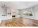 Bright, open living room featuring a fireplace, built-in bookcases, and wood floors at 8418 Mesic Ct, Indianapolis, IN 46278