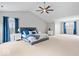 Large primary bedroom with vaulted ceiling and two windows with blue drapes at 8418 Mesic Ct, Indianapolis, IN 46278