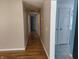 Long hallway with hardwood floors and neutral walls at 108 W 650 South, Pendleton, IN 46064