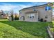 View of the backyard featuring a large lawn and neutral vinyl siding with trees and shrubs at 612 Reunion Ln, Greenwood, IN 46143