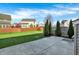 Grassy backyard featuring concrete patio area, perimeter fence, and mature trees for privacy at 612 Reunion Ln, Greenwood, IN 46143