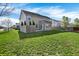 Spacious lawn and backyard of neutral vinyl siding home with mature tree accents and green lawn at 612 Reunion Ln, Greenwood, IN 46143