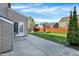 Spacious backyard featuring concrete patio, large green lawn and perimeter fence for privacy at 612 Reunion Ln, Greenwood, IN 46143