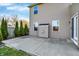 Backyard concrete patio with neutral siding home featuring trimmed shrubs and a small storage structure at 612 Reunion Ln, Greenwood, IN 46143