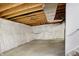 Unfinished basement features exposed beams and plastic-covered walls for potential finishing at 612 Reunion Ln, Greenwood, IN 46143
