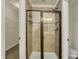 Tiled shower with glass door and built in storage and toilet with white trim at 612 Reunion Ln, Greenwood, IN 46143