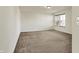 Spacious bedroom with neutral walls, plush carpeting and large window letting in natural light at 612 Reunion Ln, Greenwood, IN 46143