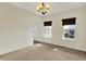 Dining room showcases neutral carpet, a decorative light fixture, and window with woven shades at 612 Reunion Ln, Greenwood, IN 46143