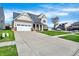 Traditional two-story home with an attached two-car garage and long driveway, perfect for guest parking at 612 Reunion Ln, Greenwood, IN 46143