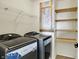 This laundry room has a washer and dryer, shelving, and a folding table at 612 Reunion Ln, Greenwood, IN 46143