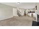 Spacious living room with a cozy fireplace leading to open kitchen and staircase at 612 Reunion Ln, Greenwood, IN 46143
