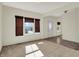 Comfortable living room showcasing large windows with woven blinds and neutral carpeting at 612 Reunion Ln, Greenwood, IN 46143