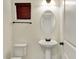 Stylish powder room with a pedestal sink and oval mirror at 612 Reunion Ln, Greenwood, IN 46143