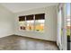 Bright sunroom featuring tile floors, neutral paint, large windows, and access to backyard through glass-paneled door at 612 Reunion Ln, Greenwood, IN 46143