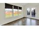 Bright sunroom featuring tile floors, neutral paint, large windows, and access to backyard through glass-paneled door at 612 Reunion Ln, Greenwood, IN 46143