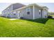 Backyard view of townhome featuring patio, lawn, and easy outdoor access at 6272 Wasco Dr, Whitestown, IN 46075
