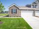 Brick facade townhome with well-maintained lawn, white garage door, and manicured landscaping at 6272 Wasco Dr, Whitestown, IN 46075