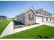 Charming townhome featuring a brick facade, well-manicured lawn, and attached garage at 6272 Wasco Dr, Whitestown, IN 46075