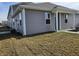 Rear view of a townhome with gray siding and white trim at 6272 Wasco Dr, Whitestown, IN 46075