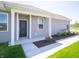 Inviting front entrance with black door, vinyl siding, and manicured landscaping at 6272 Wasco Dr, Whitestown, IN 46075