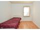 Bedroom featuring a twin bed, neutral colors, hard surface floor and a window at 850 S Holmes Ave, Indianapolis, IN 46221