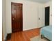 A bedroom showcasing wood-look floors, white walls, and ample closet space at 850 S Holmes Ave, Indianapolis, IN 46221