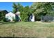 A charming home with a spacious front yard, mature trees, and a trampoline at 850 S Holmes Ave, Indianapolis, IN 46221