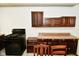 Functional kitchen with dark wood cabinets, laminate countertops, and modern black oven at 850 S Holmes Ave, Indianapolis, IN 46221