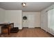 View of a living room with hard surface floors, neutral paint and multiple doorways at 850 S Holmes Ave, Indianapolis, IN 46221