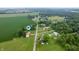 Expansive aerial view of the property showcasing its location amongst farmland and trees in a serene setting at 1504 N Knightstown Rd, Shelbyville, IN 46176