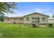 View of backyard featuring a small patio, a lush green lawn, and part of the house at 1504 N Knightstown Rd, Shelbyville, IN 46176