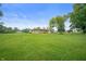 Expansive backyard featuring a large green lawn and mature trees surrounding the home at 1504 N Knightstown Rd, Shelbyville, IN 46176