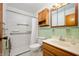 Bathroom featuring a shower-tub combo, white tiling, and a vanity, offering a clean and functional space at 1504 N Knightstown Rd, Shelbyville, IN 46176