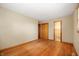Bright bedroom boasts hardwood floors, neutral walls, and a view into the connected bathroom at 1504 N Knightstown Rd, Shelbyville, IN 46176