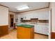 Well-lit kitchen with white cabinets and an island at 1504 N Knightstown Rd, Shelbyville, IN 46176